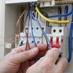 Electrician installing a new fuse box