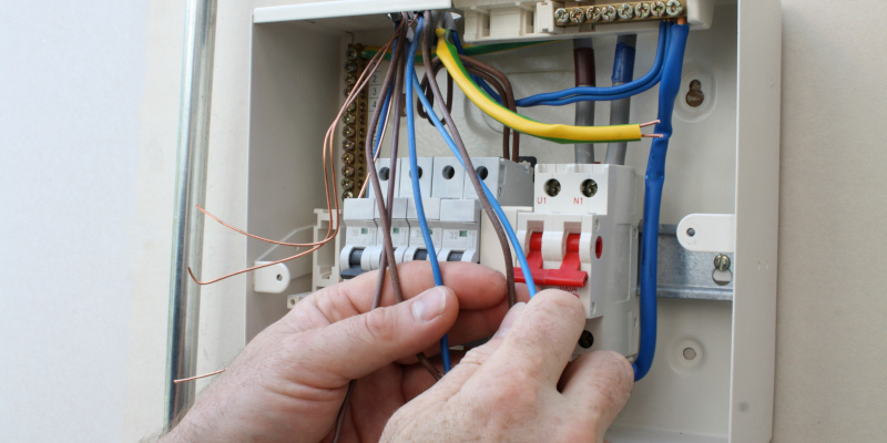 Electrician installing a new fuse box