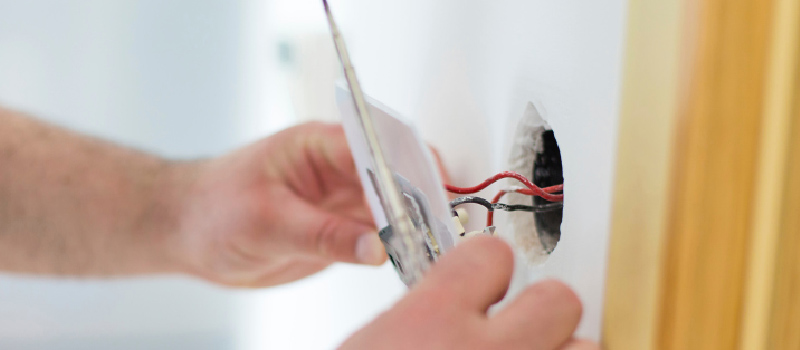 Electrician connecting up a fuse box. Electrical Rewiring in Mint Hill, North Carolina